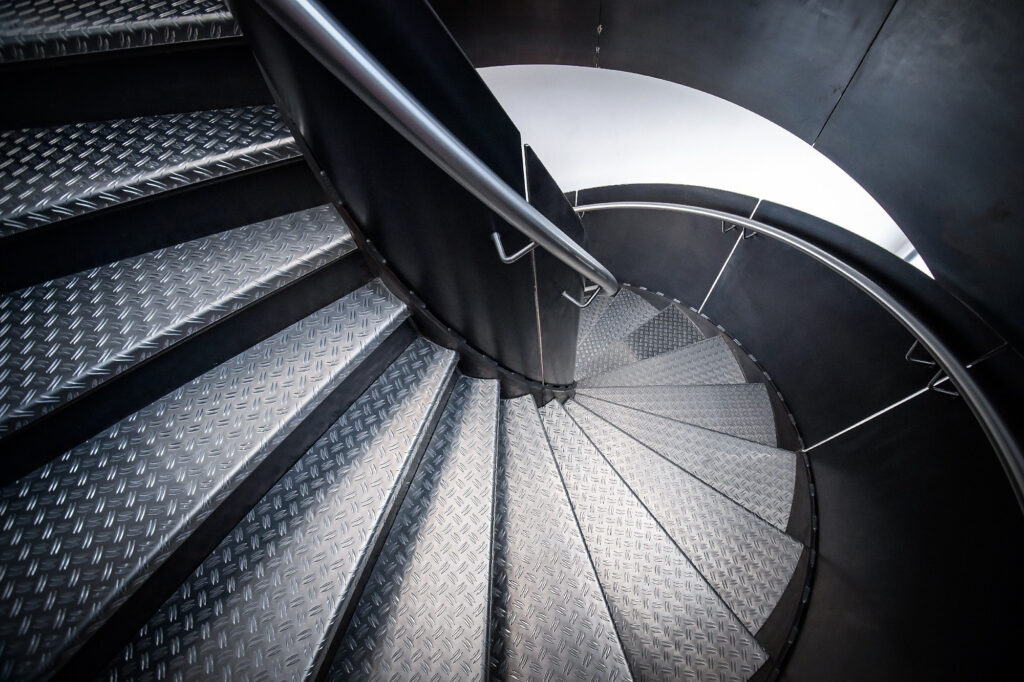 Metallwendeltreppe, industrielle Atmosphäre, modern.